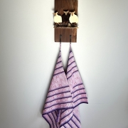 Three sheep on a wood plaque with hooks and towels