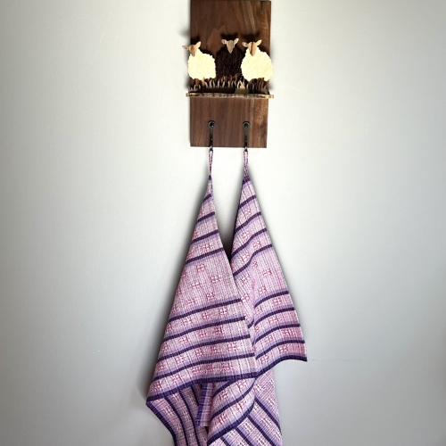 Three sheep on a wood plaque with hooks and towels